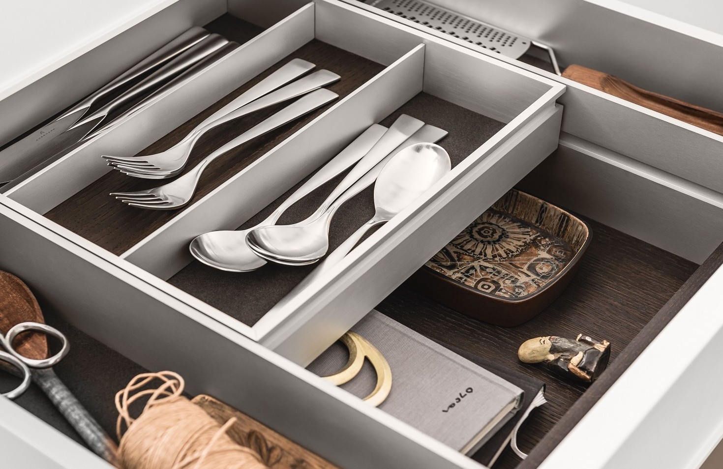 A bi-level drawer elegantly doubles storage space in SieMatic kitchen drawers and pull-outs